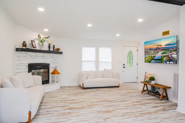 a living room with furniture and a fireplace