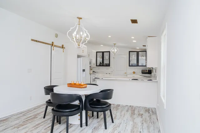 a view of a dining room with furniture and wooden floor