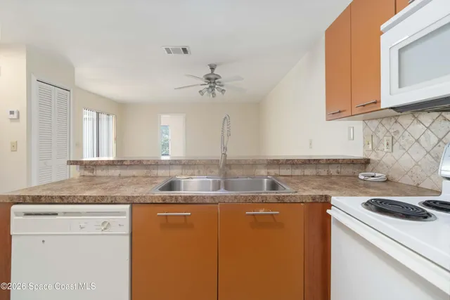 a kitchen with stainless steel appliances granite countertop a sink a stove and cabinets