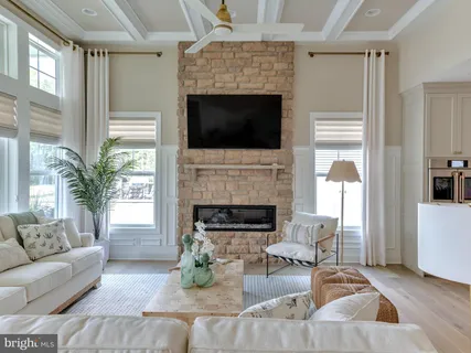 a living room with fireplace furniture and a flat screen tv