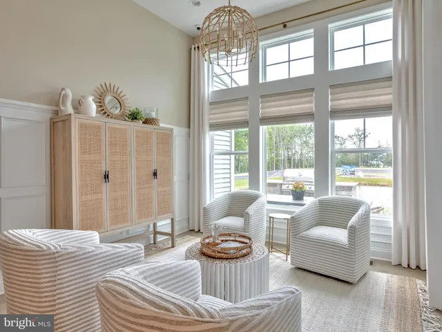 a view of a dining room with furniture a livingroom and chandelier