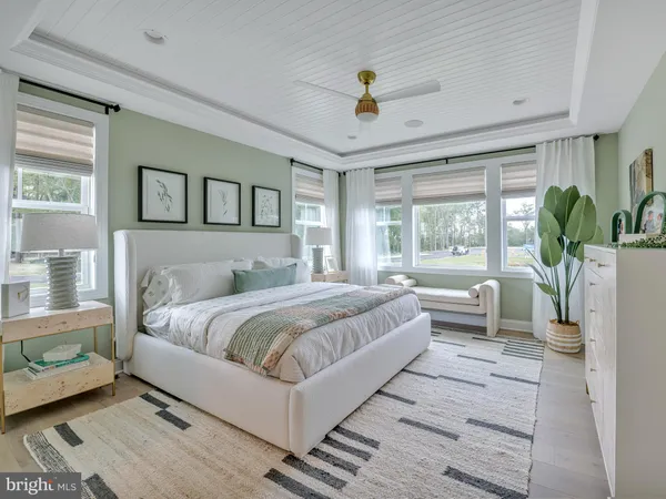 a bedroom with furniture and a large window