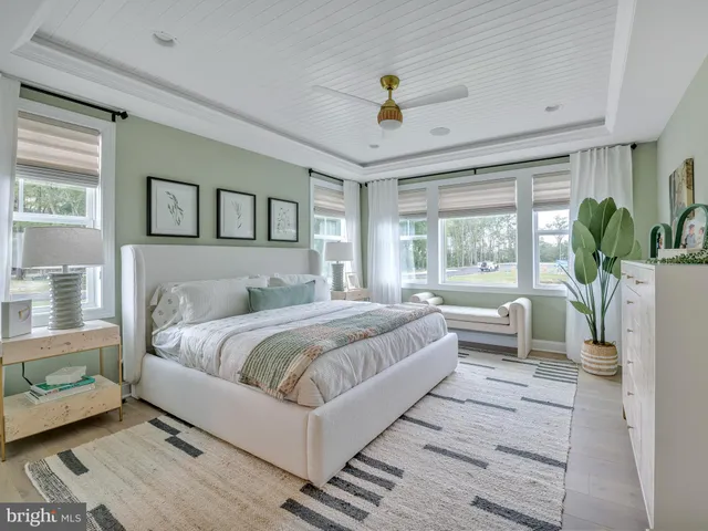 a bedroom with furniture and a large window