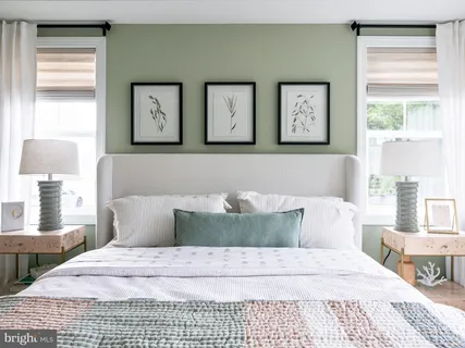 a bedroom with a large bed and a dresser