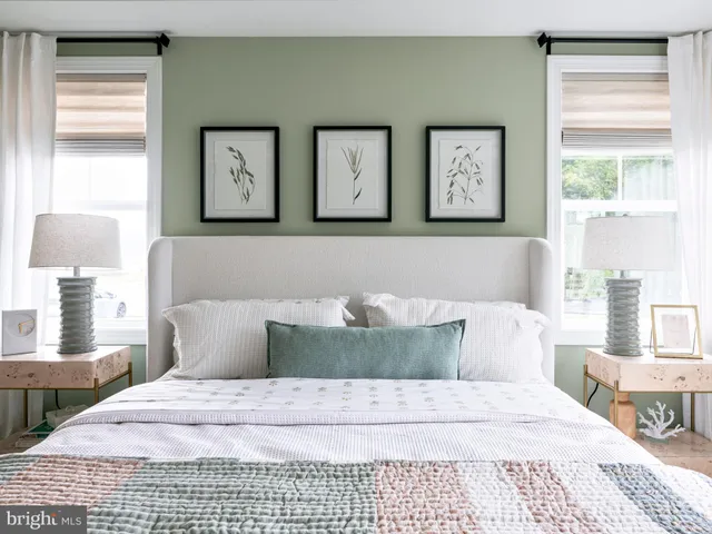 a bedroom with a large bed and a dresser