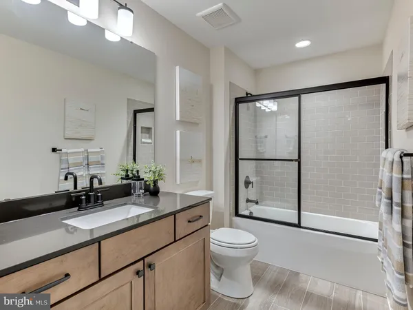 a spacious bedroom with a bed and a couch