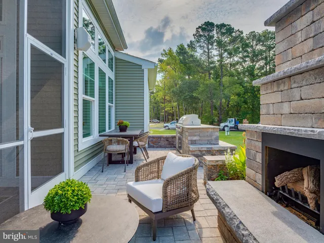 a view of a brick house with a chairs in patio