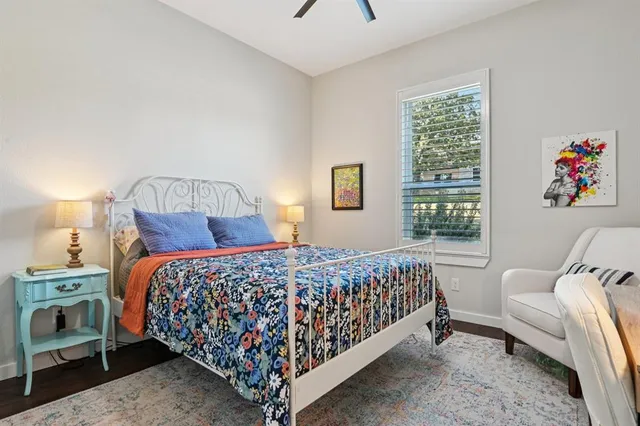 a bedroom with a bed a couch and a window