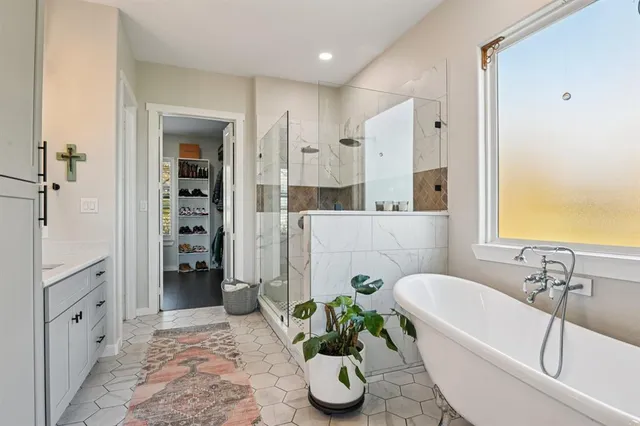 a bathroom with a tub shower and a sink