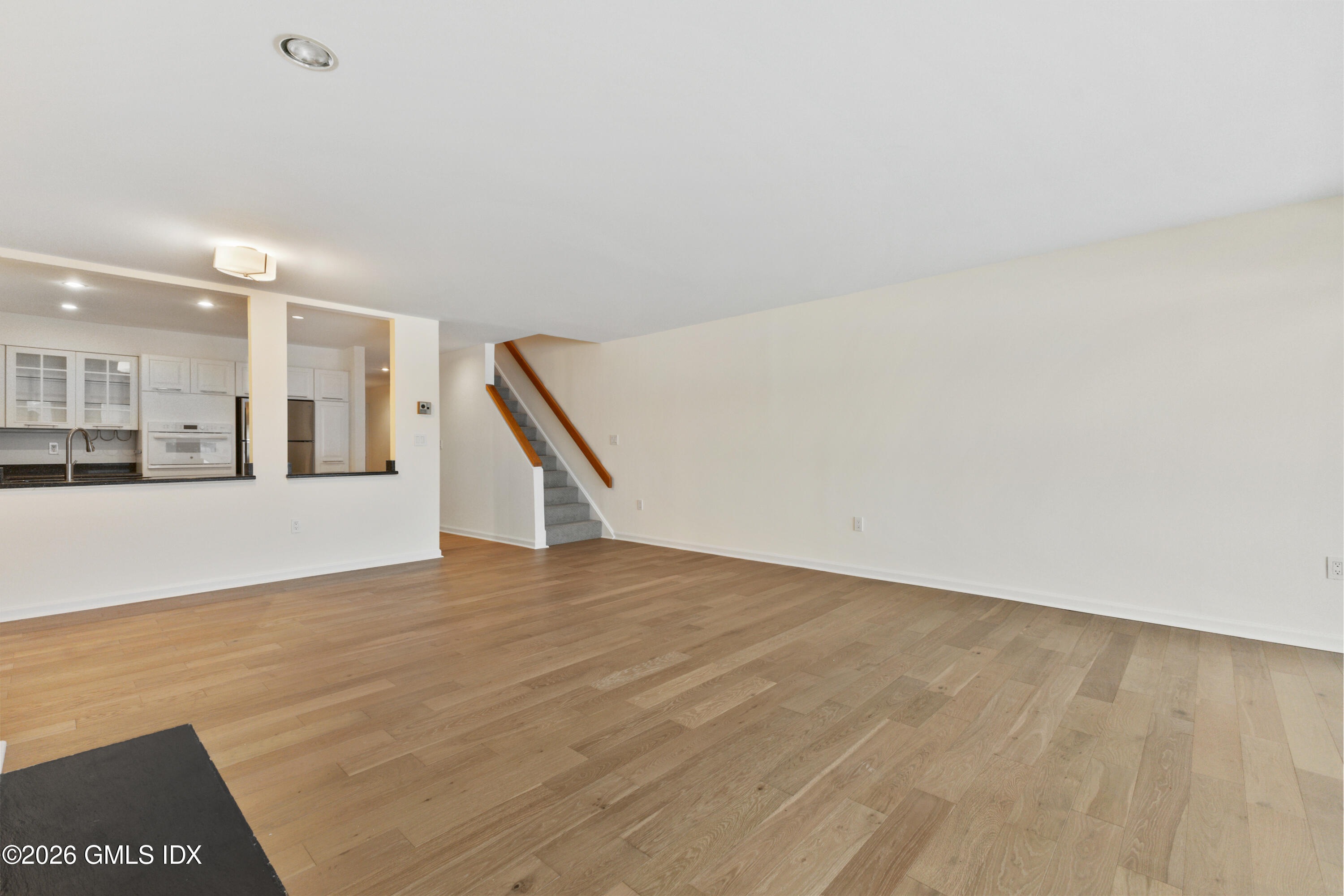 15 River Road, Unit 210 Cos Cob, CT 06807 - Photo 15 of 23 a view of an empty room with wooden floor