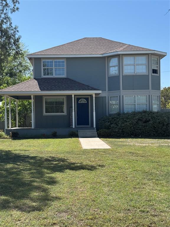 View of front of property featuring a front yard, with a wrap around porch