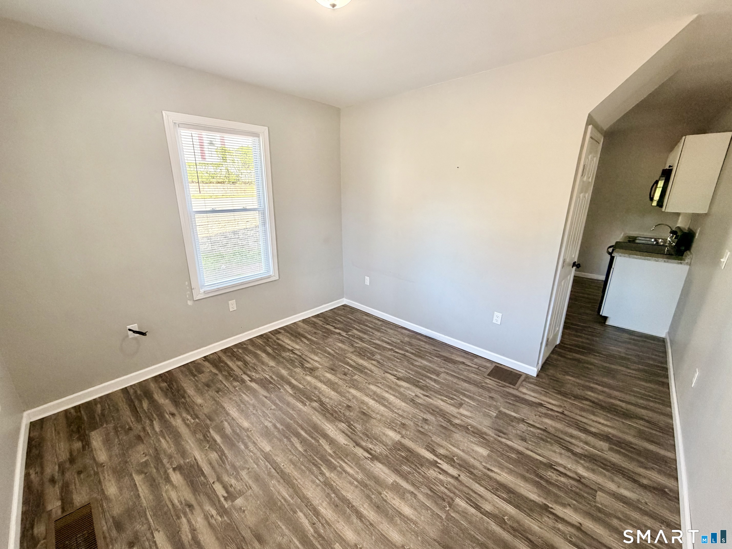 151 West Center Street Southington, CT 06489 - Photo 2 of 11 an empty room with wooden floor and a window