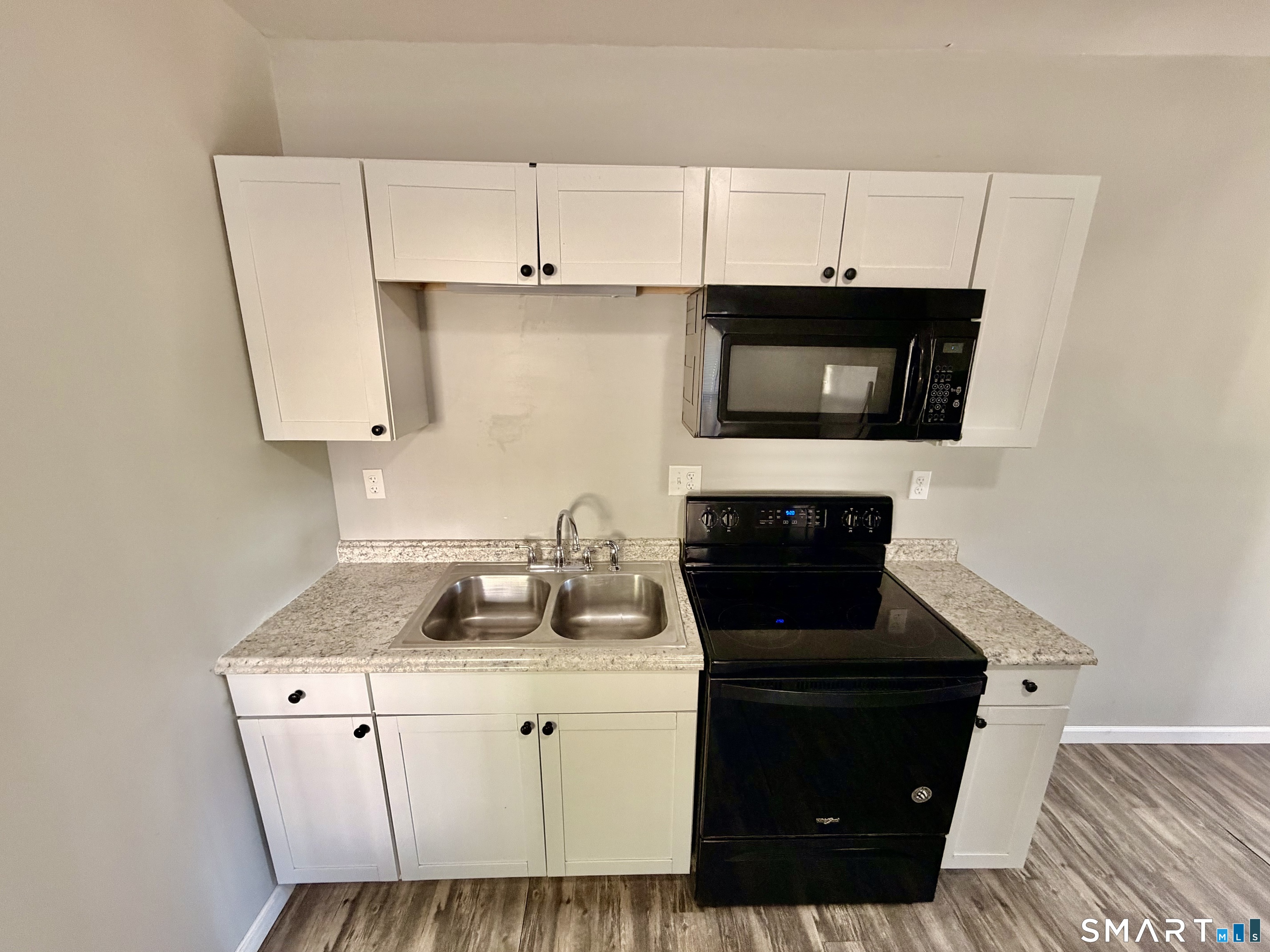 151 West Center Street Southington, CT 06489 - Photo 4 of 11 a kitchen with a stove and a microwave