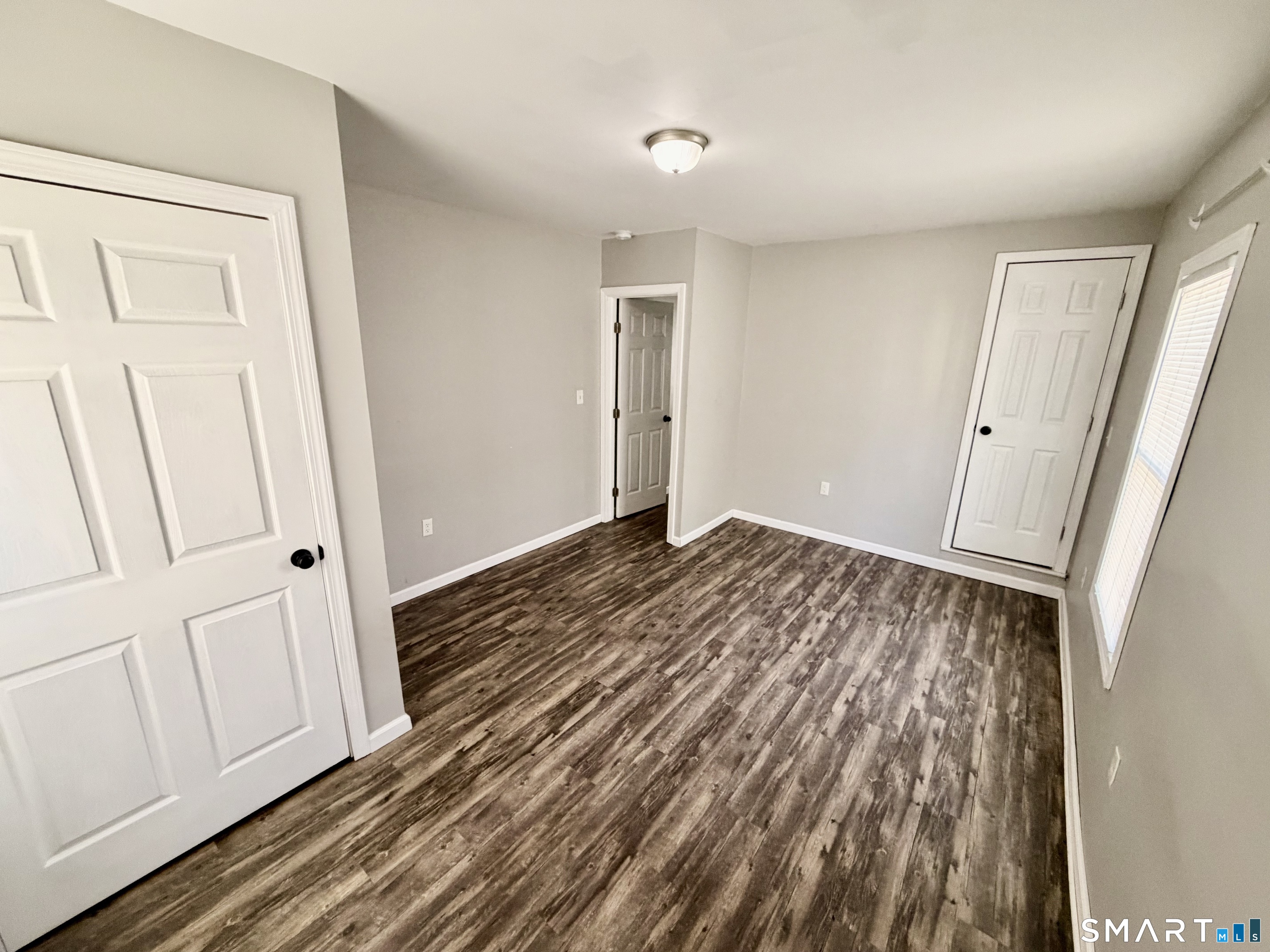 151 West Center Street Southington, CT 06489 - Photo 10 of 11 a view of a room with wooden floor and white doors