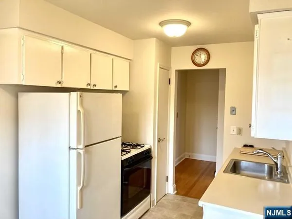 a kitchen with a refrigerator and a sink