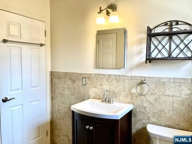 a bathroom with a sink a mirror and a toilet