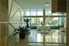 79 Southwest 12th Street, Unit 1407 Miami, FL 33130 - Photo 7 of 16 a living room with large windows