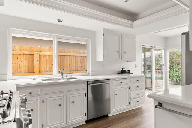 a stove top oven sitting inside of a kitchen