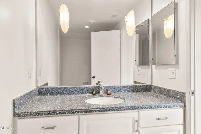 a front view of a house with sitting area and garden