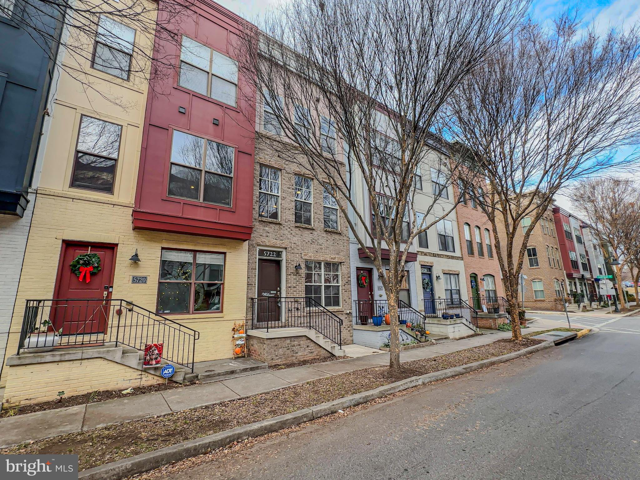 a street sign on a sidewalk next to a building