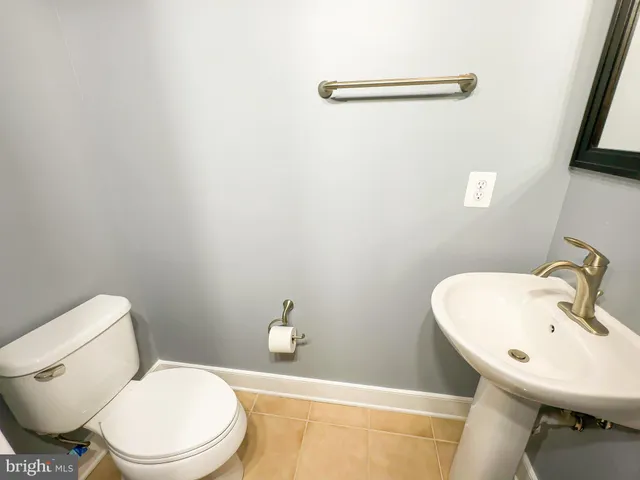 a white toilet sitting next to a bathroom sink