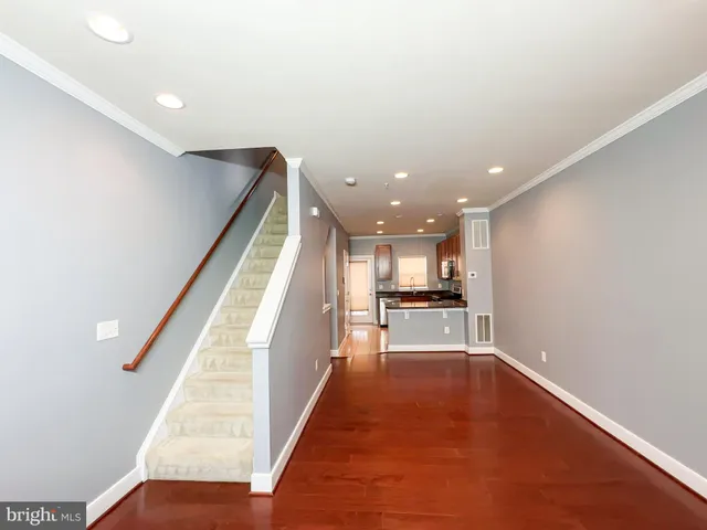 a view of a kitchen with a sink and dishwasher wooden floor
