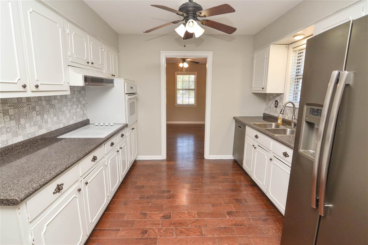 581 Fletcher Road Collierville, TN 38017 - Photo 3 of 19 a kitchen with stainless steel appliances granite countertop a sink stove and refrigerator