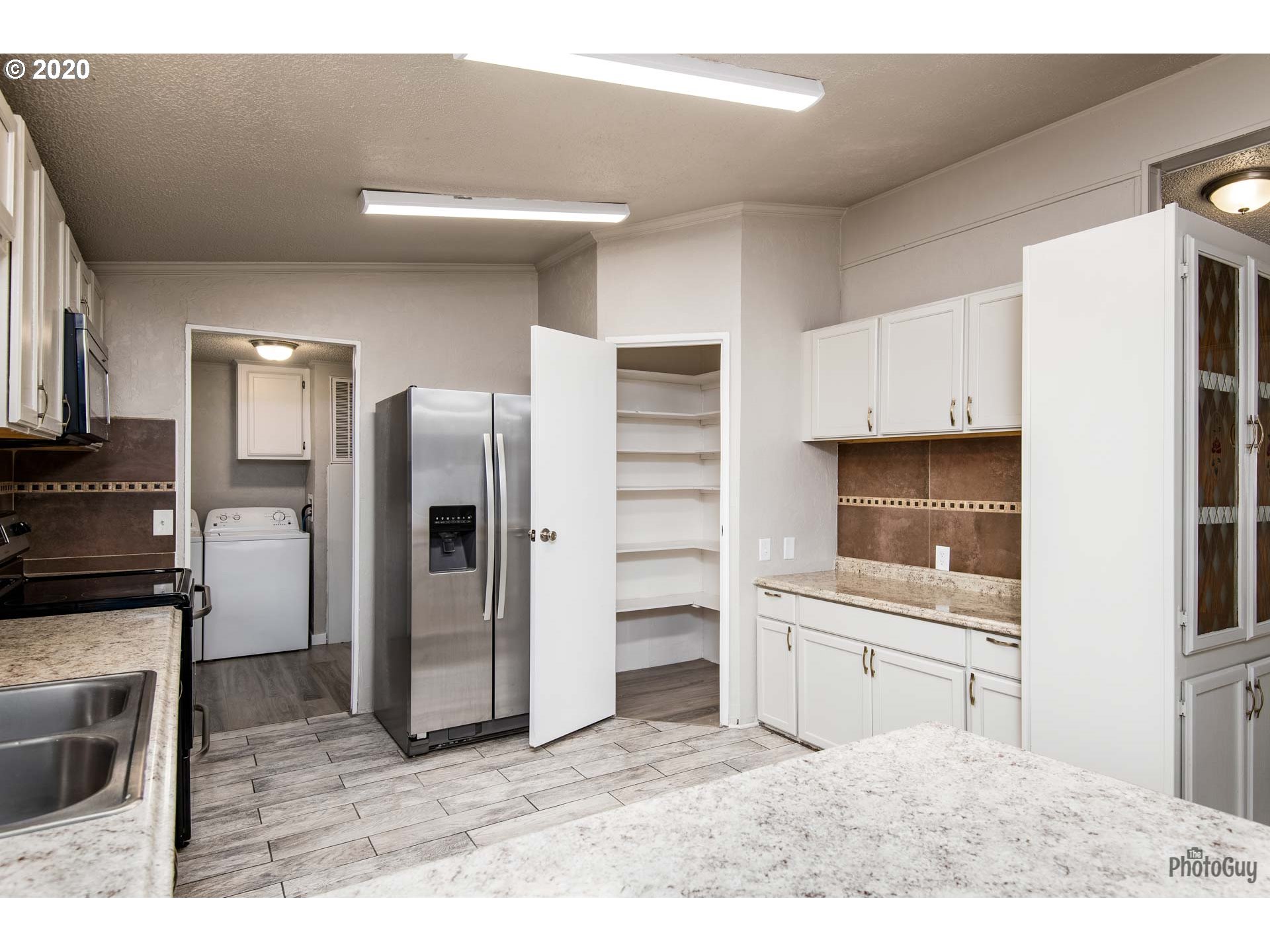 1053 South 58th Street Springfield, OR 97478 - Photo 11 of 32 a kitchen with a refrigerator and a sink