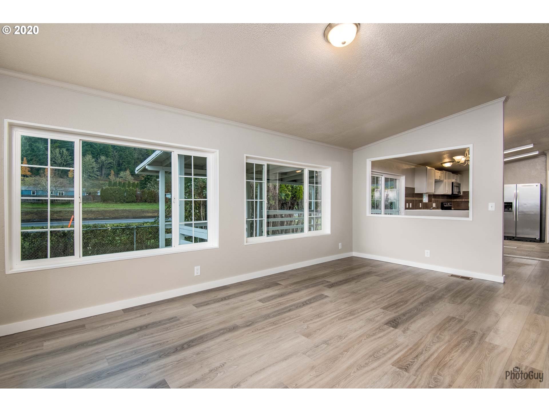 1053 South 58th Street Springfield, OR 97478 - Photo 16 of 32 a view of an empty room with wooden floor and windows