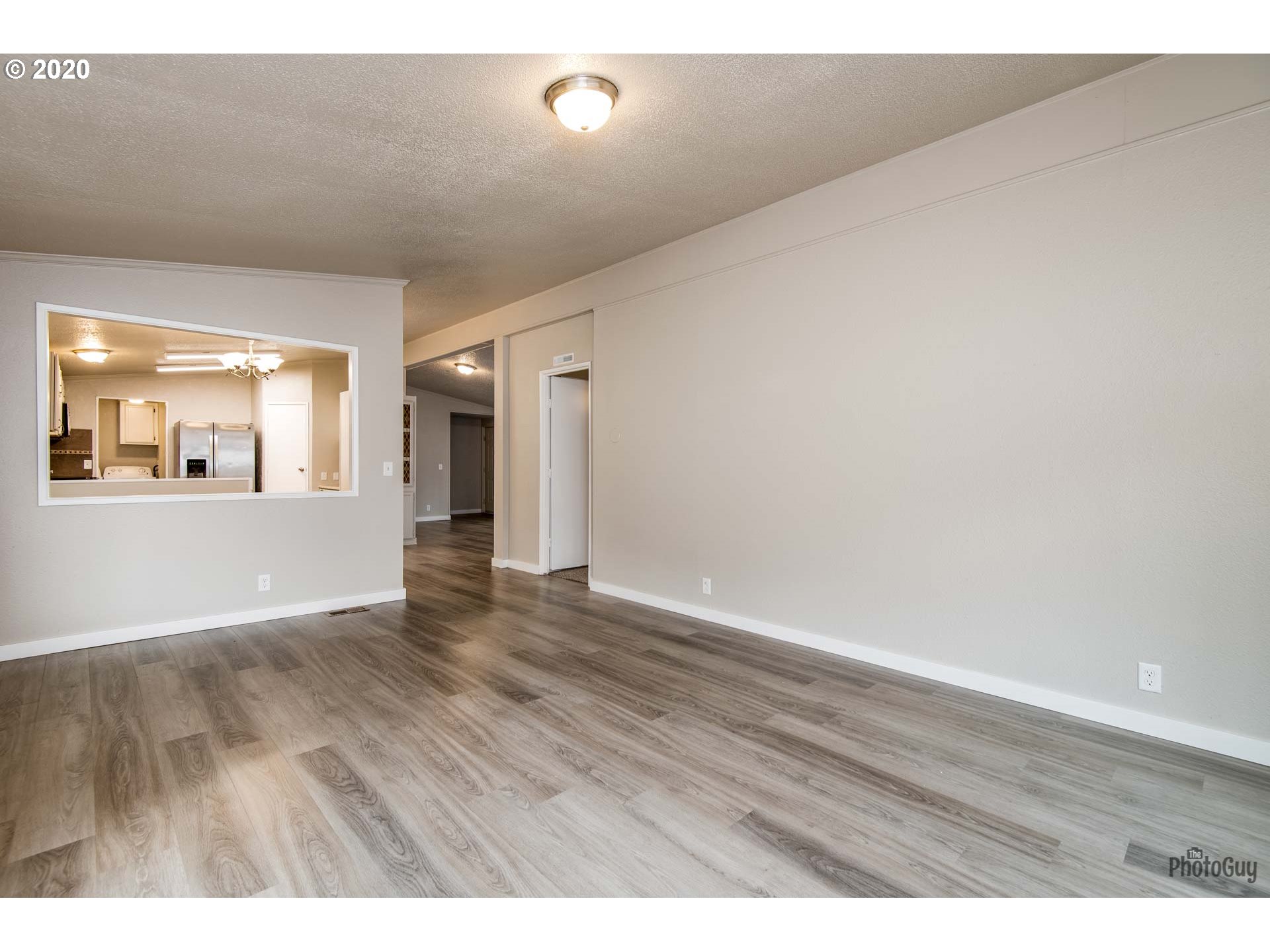 1053 South 58th Street Springfield, OR 97478 - Photo 17 of 32 a view of an empty room with wooden floor and a window