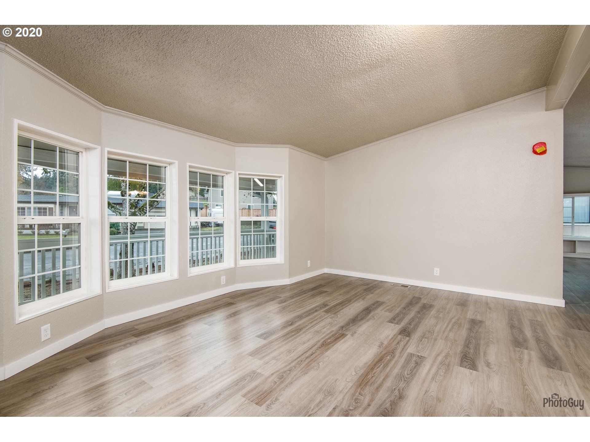 1053 South 58th Street Springfield, OR 97478 - Photo 3 of 32 a view of an empty room with wooden floor and windows