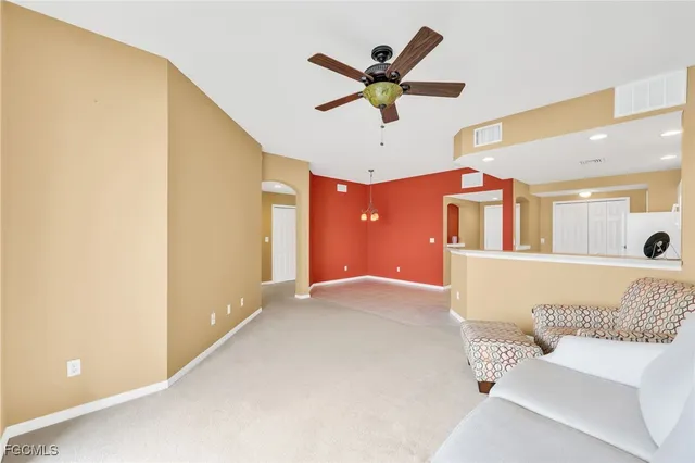 a living room with furniture and a ceiling fan