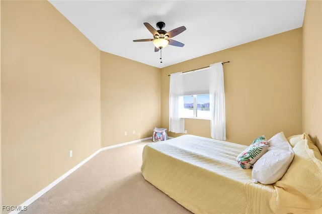 a bedroom with a bed and a ceiling fan