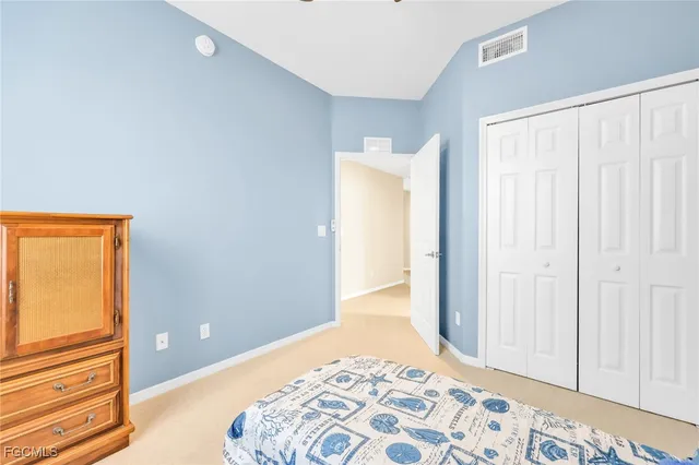 a view of a bedroom with a bed and wooden floor