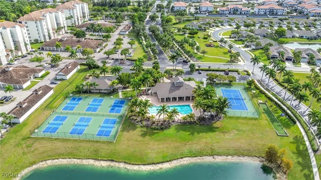 a aerial view of a house with a yard and lake view