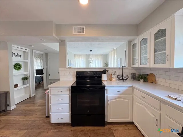 a bathroom with a toilet and a shower curtain