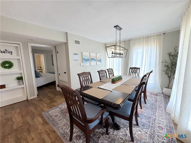 a living room with furniture and view of kitchen