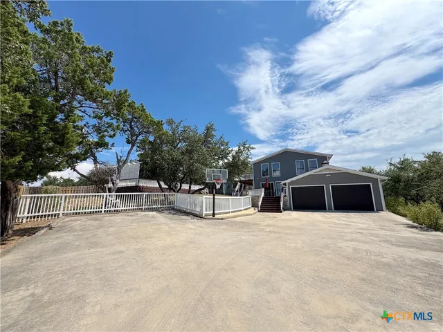 a view of house with swimming pool and sitting area