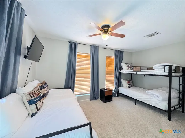 an aerial view of residential houses with outdoor space and trees