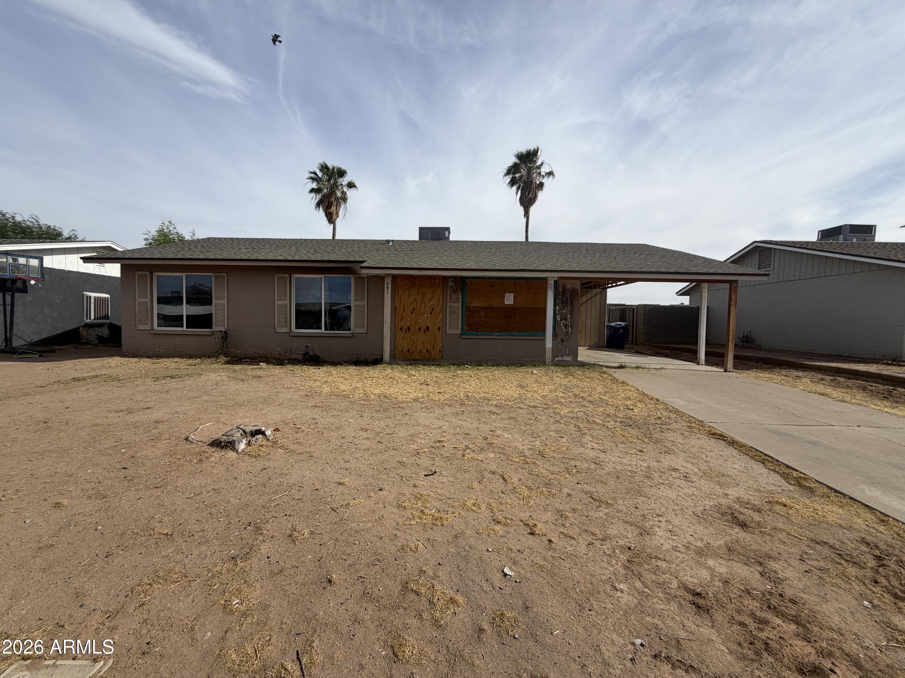 231 West Rhodes Avenue Avondale, AZ 85323 - Photo 1 of 7 a view of a house with a patio