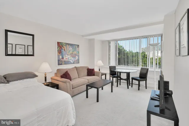 a spacious bedroom with two beds and a large window