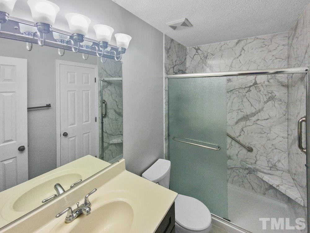 8236 Merriweather Circle Raleigh, NC 27616 - Photo 4 of 15 a bathroom with a sink toilet and shower