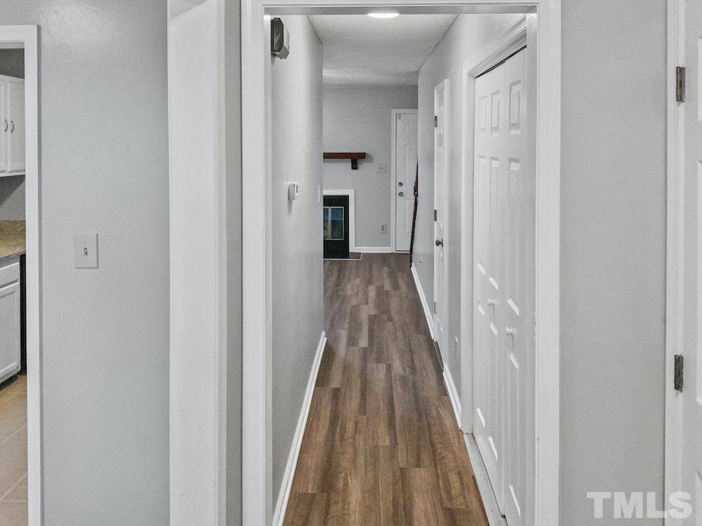 8236 Merriweather Circle Raleigh, NC 27616 - Photo 7 of 15 a view of a hallway with wooden floor and a bathroom