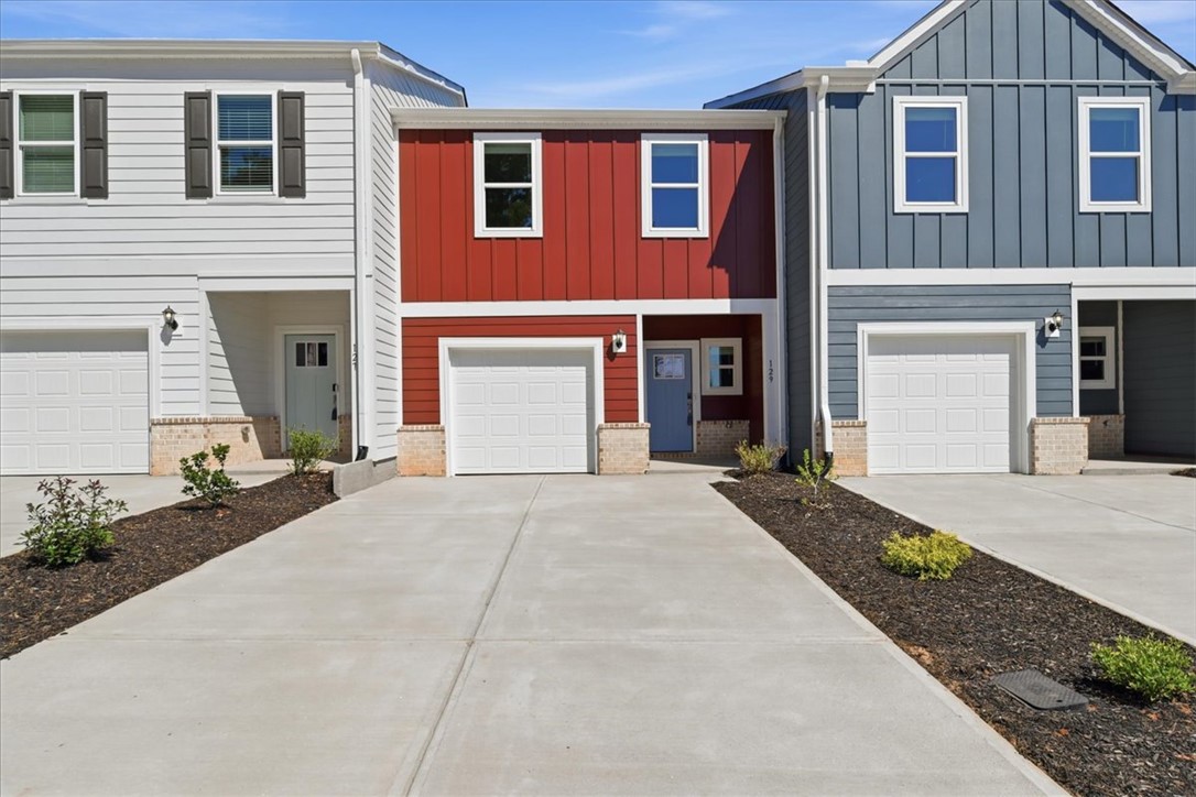 129 Kerwin Court Woodruff, SC 29388 - Photo 1 of 30 Attached garages and individual entries distinguish each modern facade in this vibrant row of townhomes.