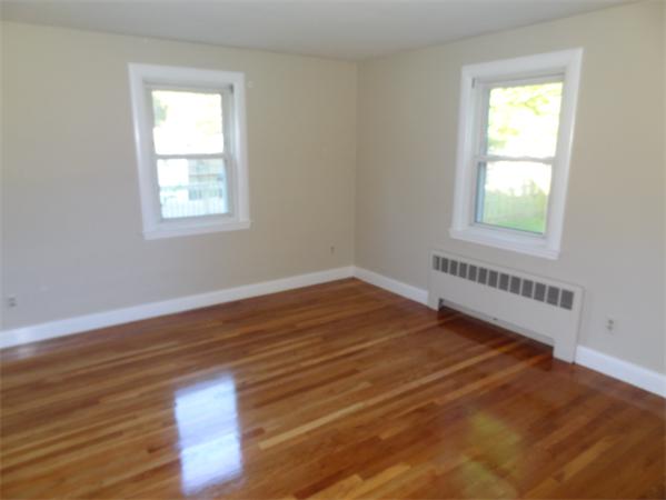 15 Dustin Road Reading, MA 01867 - Photo 4 of 11 a view of an empty room with wooden floor and a window