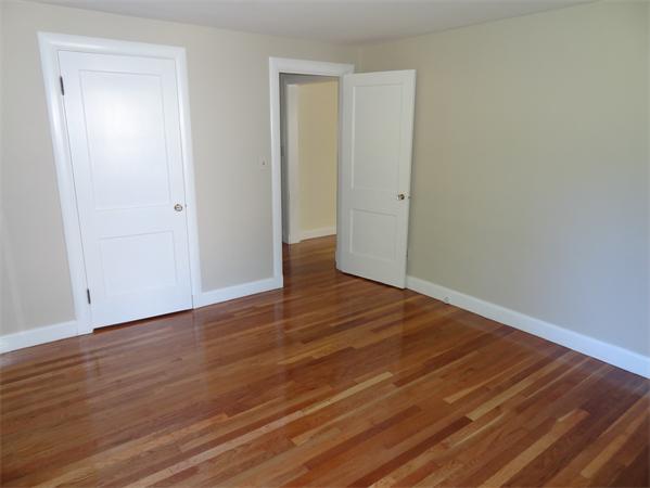15 Dustin Road Reading, MA 01867 - Photo 6 of 11 a view of an empty room with wooden floor