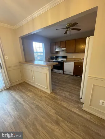a kitchen with stainless steel appliances a refrigerator and a stove top oven
