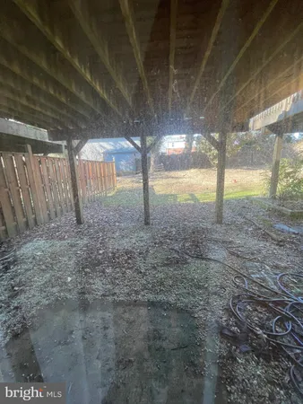 a view of an empty room with floor to ceiling window and tree