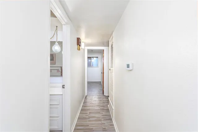 a view of a hallway with wooden floor