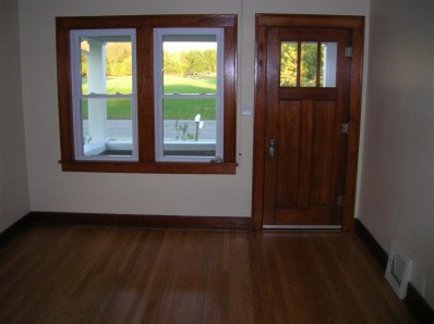 9428 Kleinman Road Highland, IN 46322 - Photo 5 of 10 an empty room with wooden floor and windows